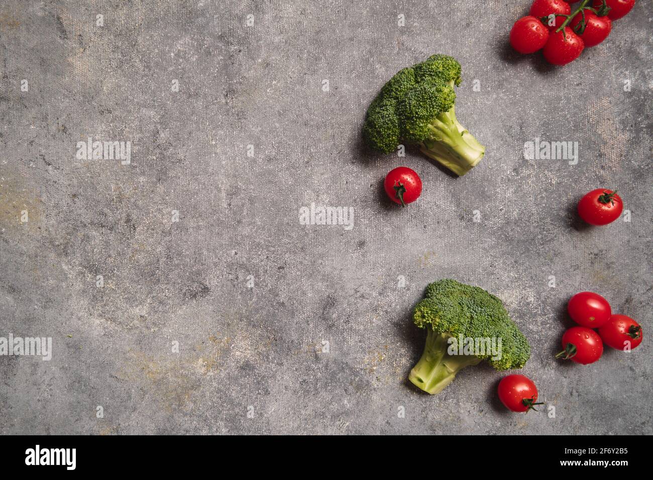 Broccoli and tomatoes on gray background Stock Photo