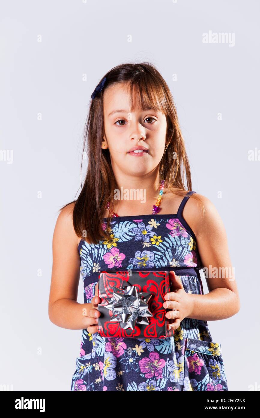 Happy little girl holding a gift box Stock Photo