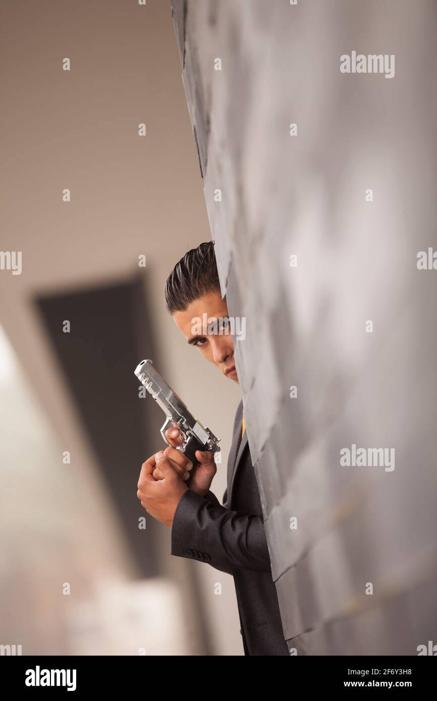 Powerful security businessman aiming a gun Stock Photo