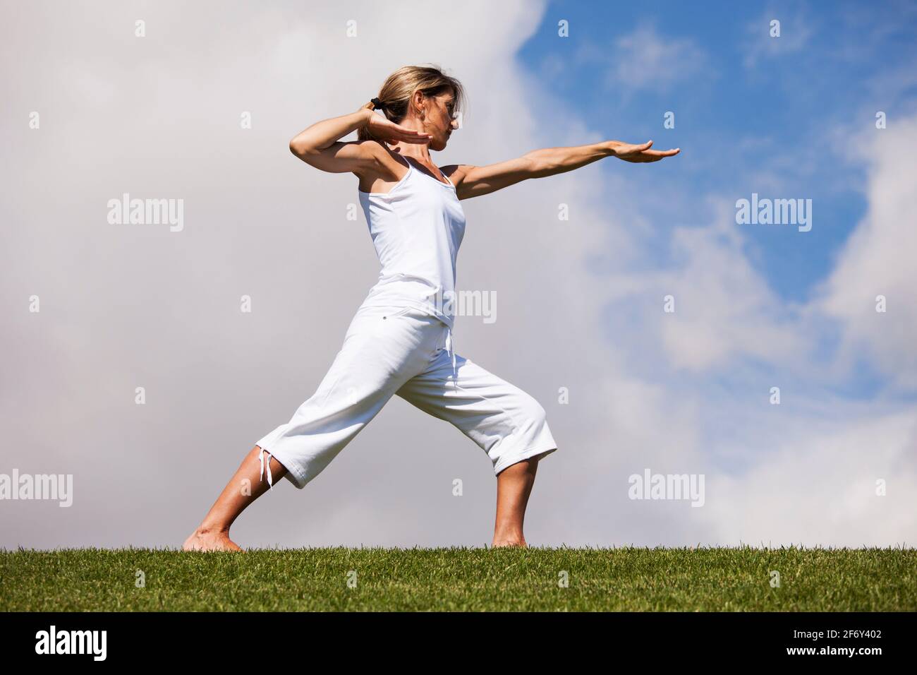 young woman making exercise in a field Stock Photo