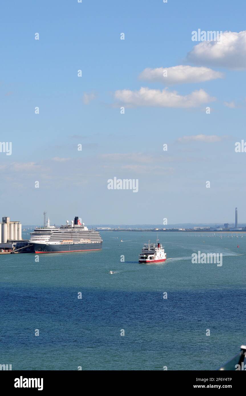 'Red Falcon' passing 'Queen Victoria' on its way to Southampton from the Isle of Wight. Stock Photo