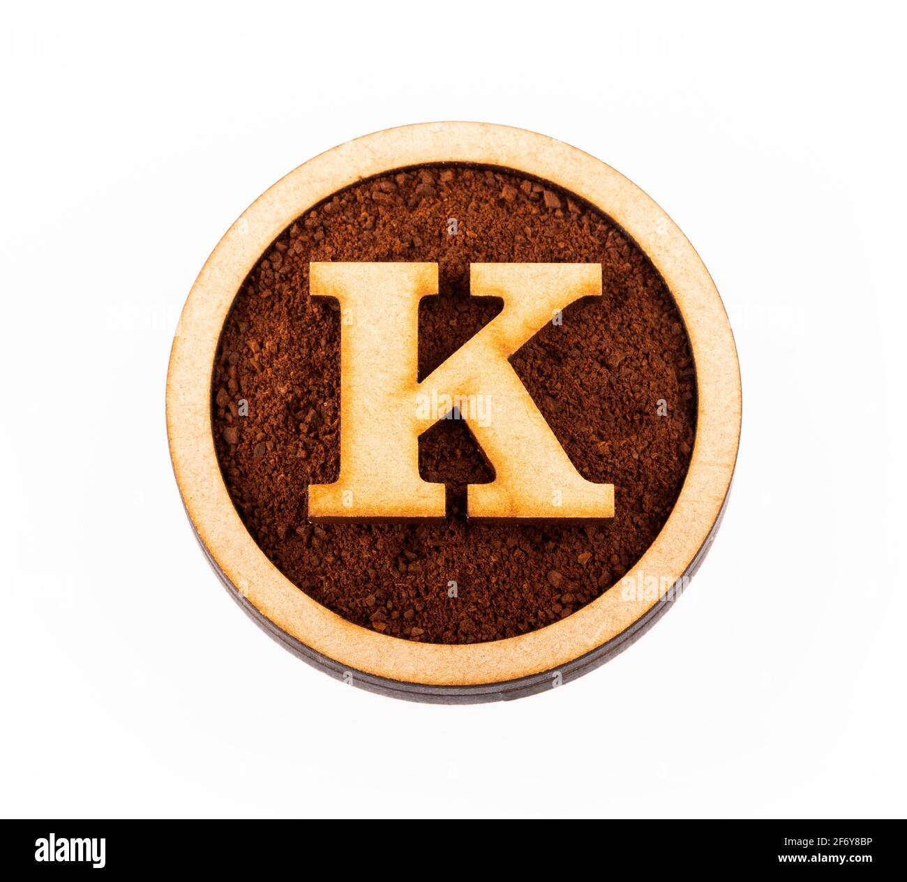 K, wooden alphabet letter - Ground organic coffee. Coffea Stock Photo