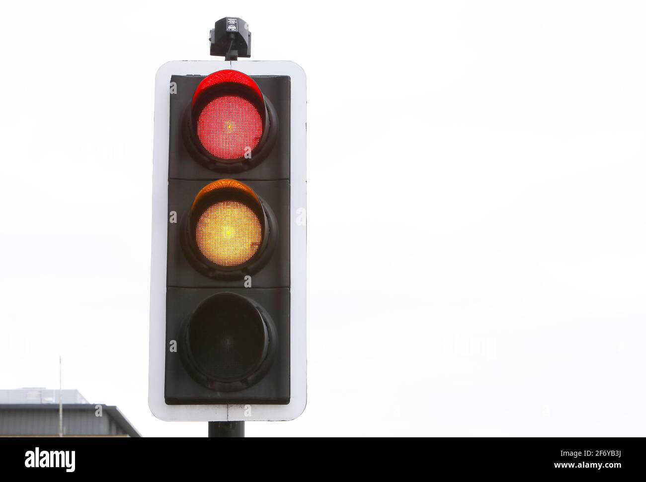Traffic light changing from red to amber, UK Stock Photo