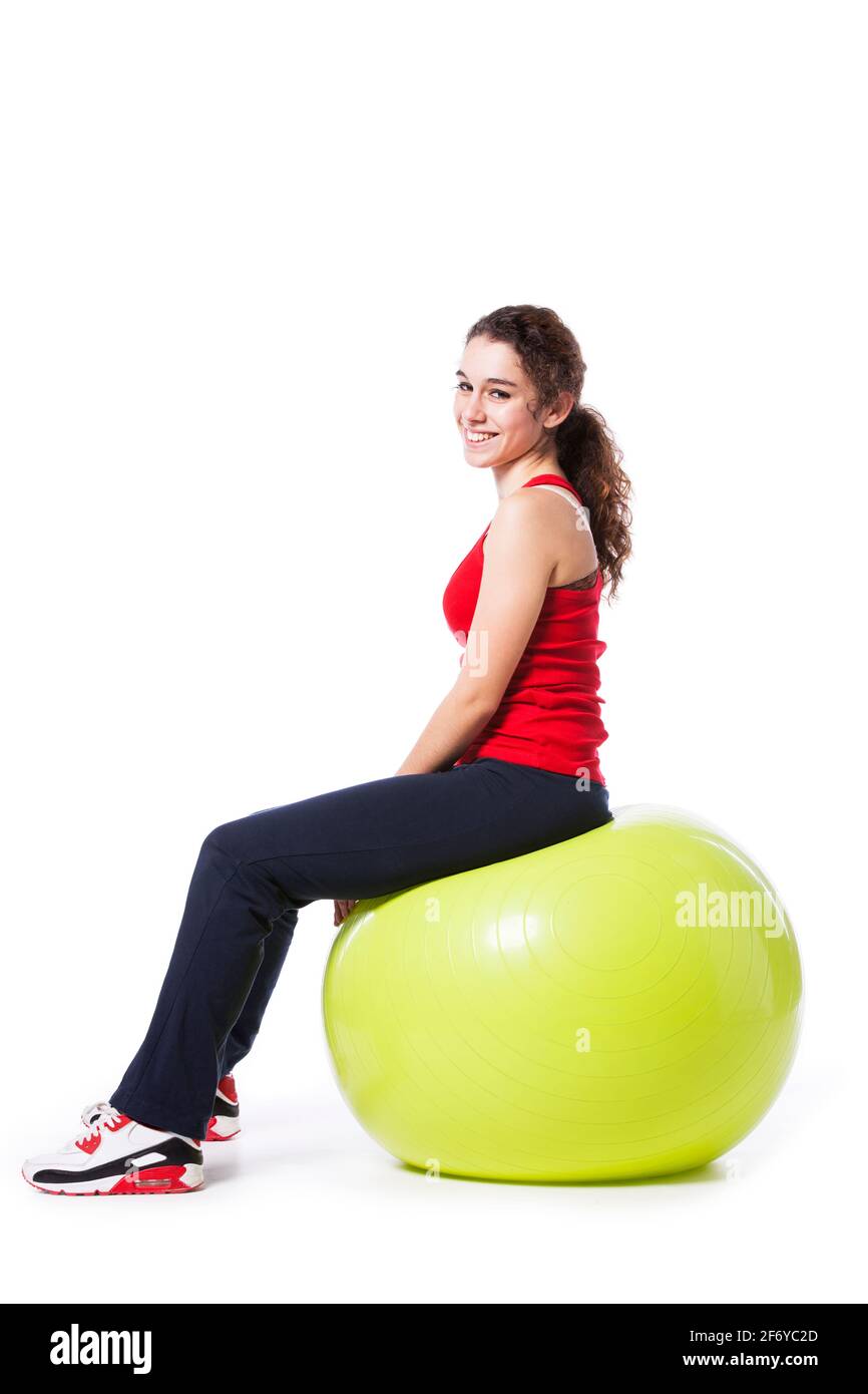 Young woman relaxing after workout exercise ball (isolated on white) Stock Photo