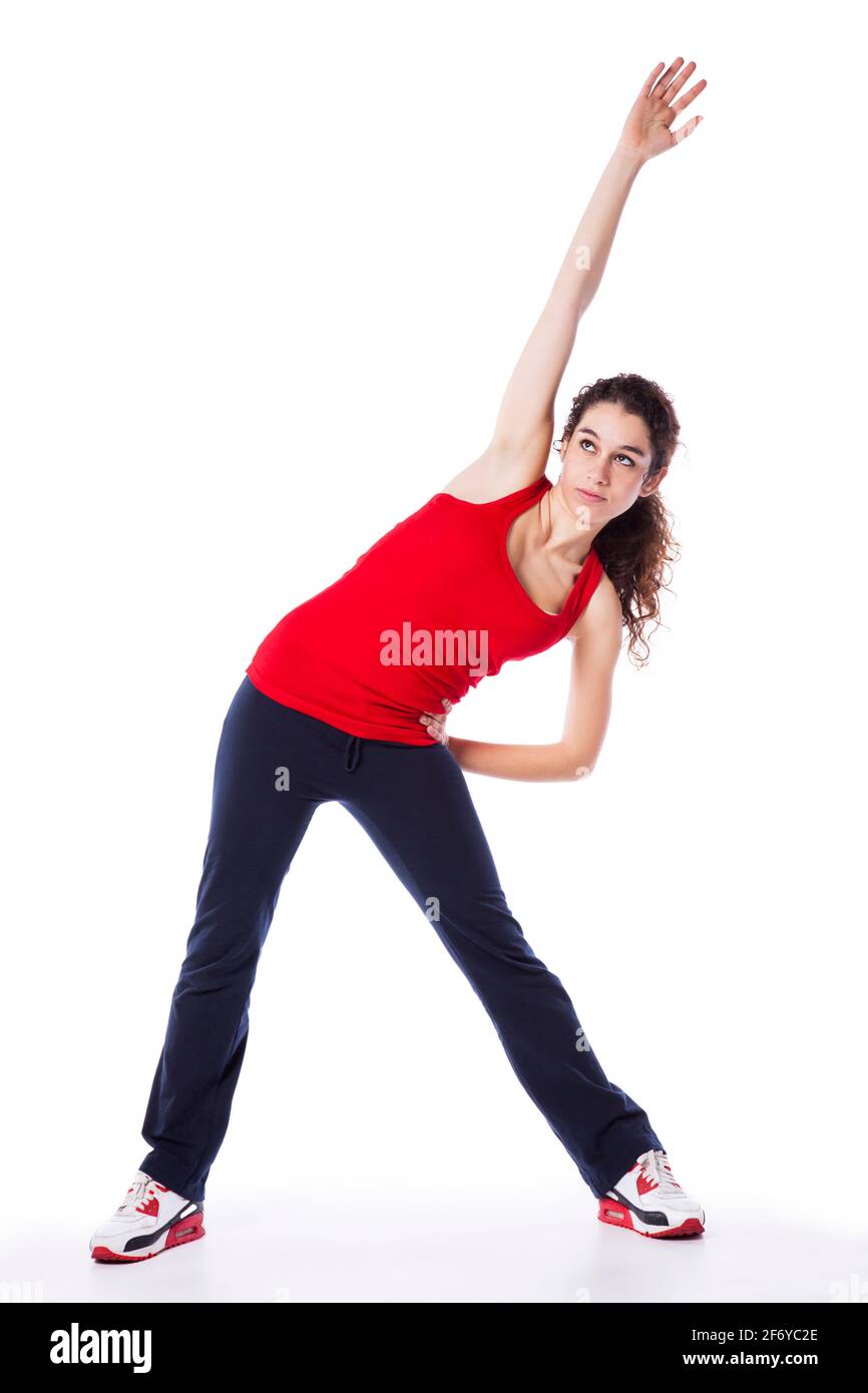 Young woman exercising and stretching (isolated on white) Stock Photo