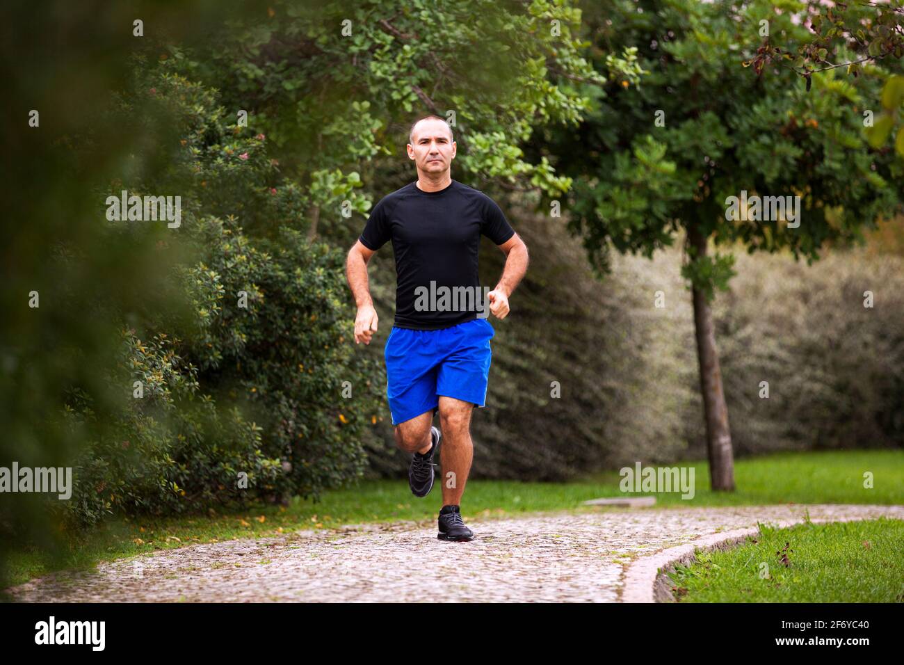 Mature man running at the city park Stock Photo