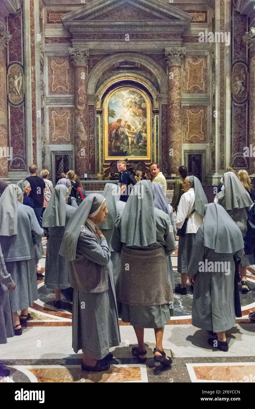 Rome, Italy - Oct 06, 2018: Nuns in front of the painting in the Cathedral of St. Peter Stock Photo
