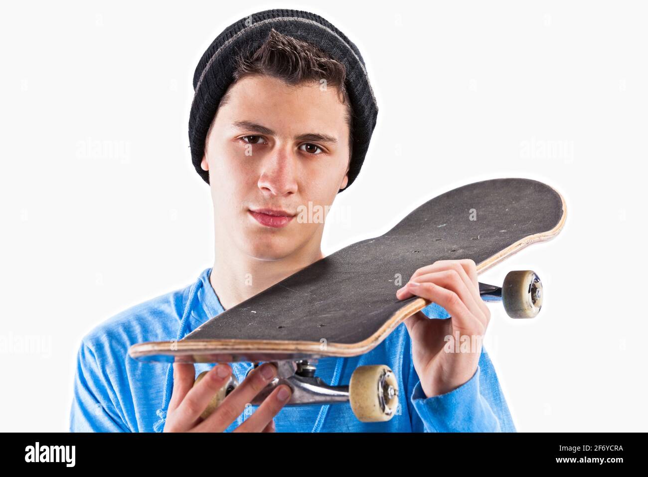 Teenager with holding a skateboard at studio Stock Photo