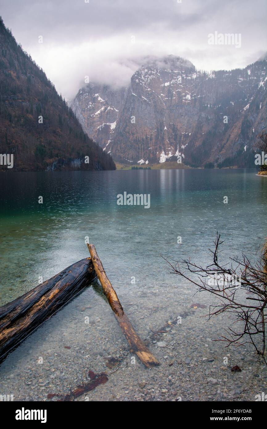 Lake Koenigssee near Berchtesgaden in Bavaria at a rainy day with mountains in the background Stock Photo