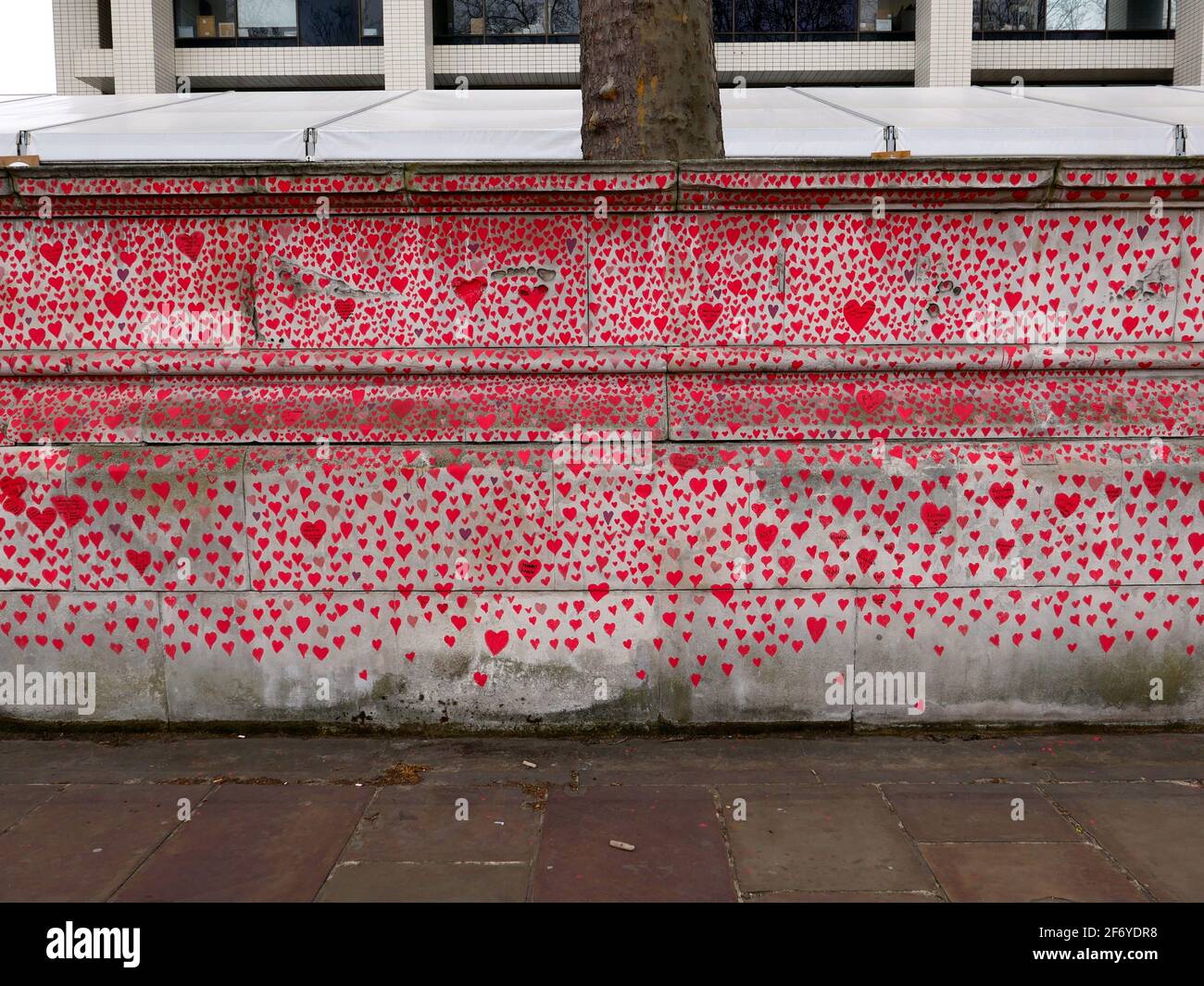 150000 hearts painted in London to represent lives lost to Covid 19 across the UK .Each heart represents someone who was loved and was lost too soon to Covid - 19 . Matt Fowler , co Founder said when they started painting the hearts .Labour leader Keir Starmer arrived and showed support . Hopefully the council will seal the hearts once they are finished so it can become a permanent memorial for those who lost there lives and hopefully a public enquiry can take place to investigate the failings of the Tory Government in order to learn lessons quickly and prevent further loss of life ... Stock Photo