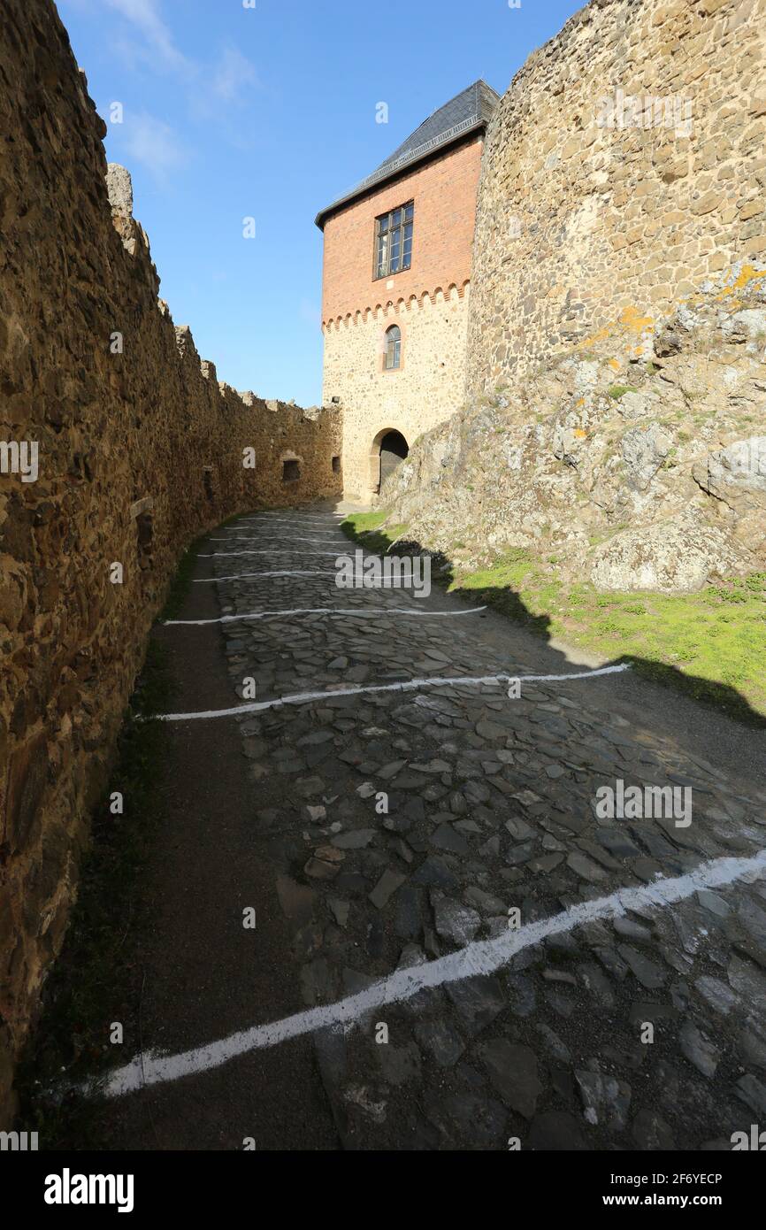 03 April 2021, Saxony-Anhalt, Pansfelde: White markings on the ground indicate the distance rules for visitors on the castle grounds. Falkenstein Castle in the southern Harz region was reopened to visitors for the first time after a long break due to the Corona pandemic. After booking by telephone, visitors can tour the castle grounds as well as experience a falconry demonstration. The castle is situated above the Selketal. The fortified complex was built at the beginning of the 12th century and passed as a fiefdom to the noble Asseburg family in the 15th century. Photo: Matthias Bein/dpa-Zent Stock Photo