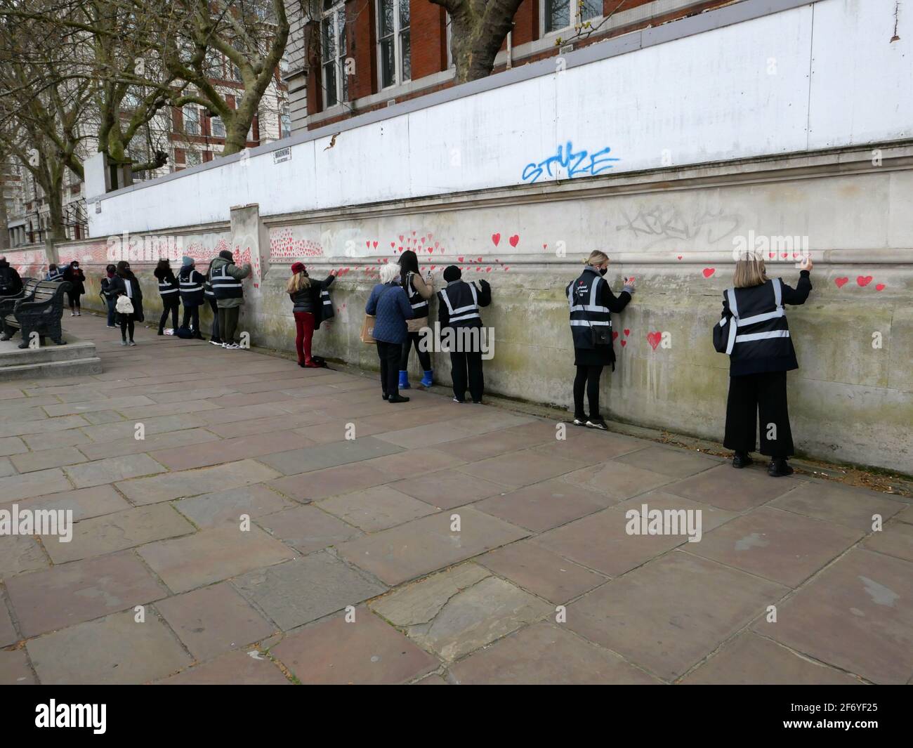 150000 hearts painted in London to represent lives lost to Covid 19 across the UK .Each heart represents someone who was loved and was lost too soon to Covid - 19 . Matt Fowler , co Founder said when they started painting the hearts .Labour leader Keir Starmer arrived and showed support . Hopefully the council will seal the hearts once they are finished so it can become a permanent memorial for those who lost there lives and hopefully a public enquiry can take place to investigate the failings of the Tory Government in order to learn lessons quickly and prevent further loss of life ... Stock Photo