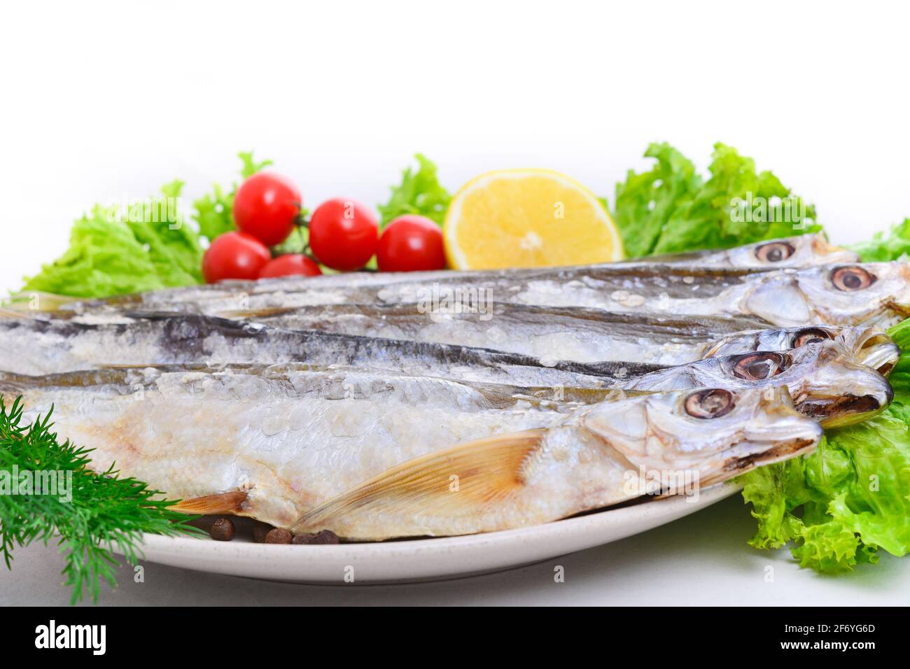 Group of dried fish at plate . Seafood Stock Photo