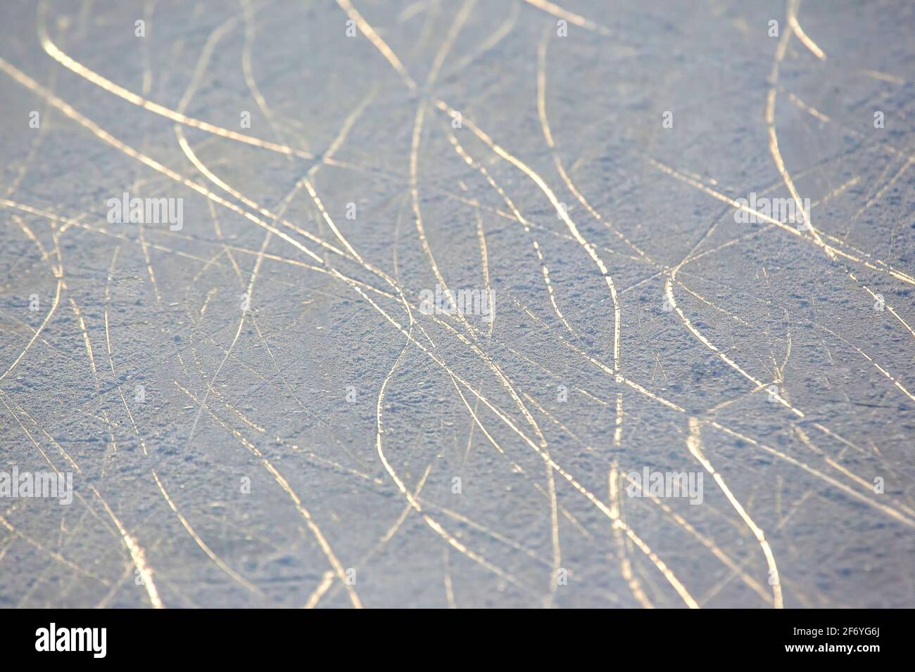 bright traces of ice skating on an ice rink. background and texture Stock Photo