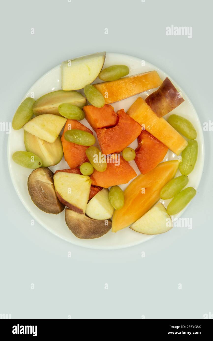 Mumbai , India 15 March 2021, Fruit salad in the plate on the white