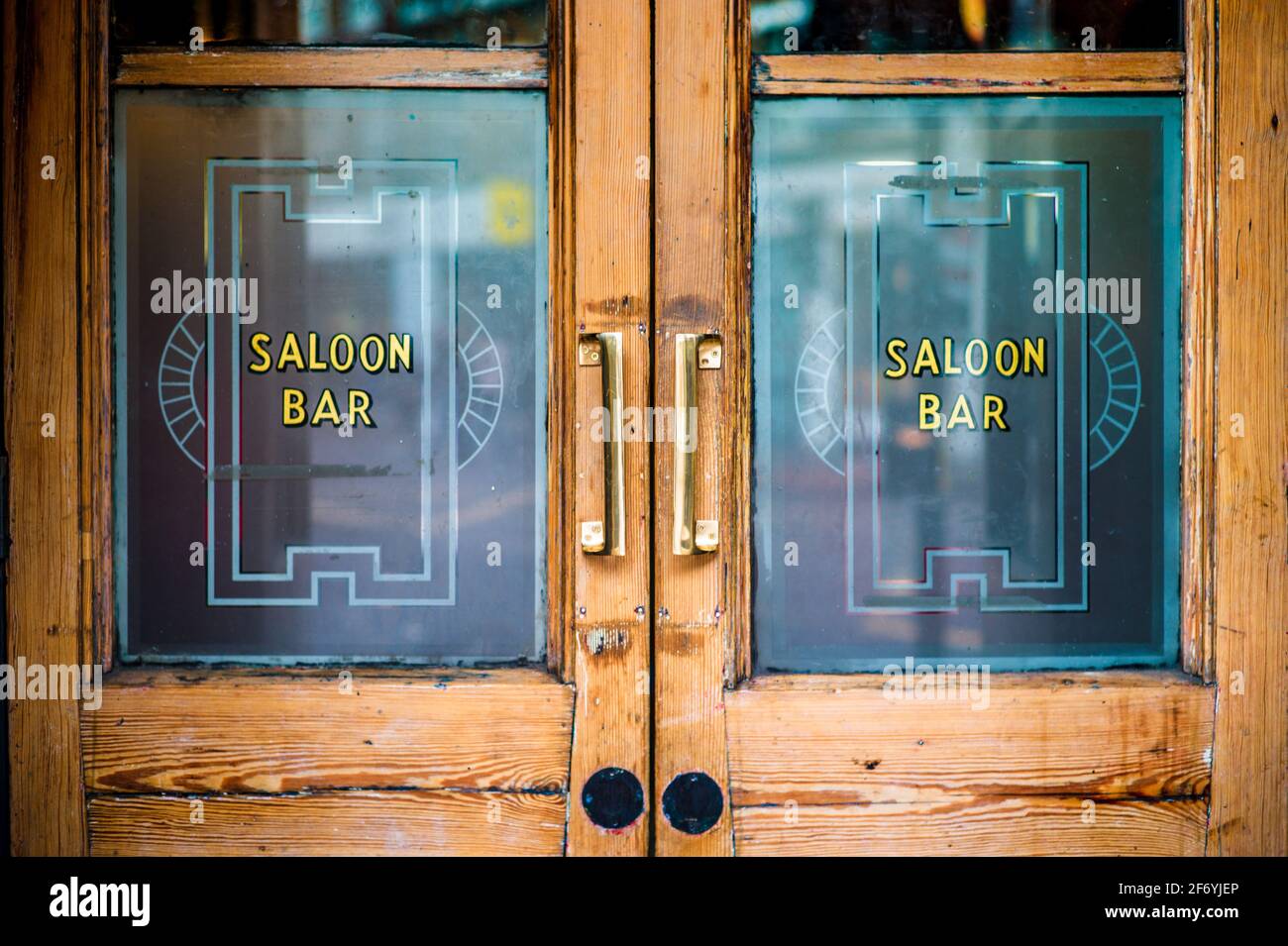Saloon Bar Doors on a London Pub - Saloon Bar London. The Saloon Bar was usually the better furnished room of a public house. Stock Photo