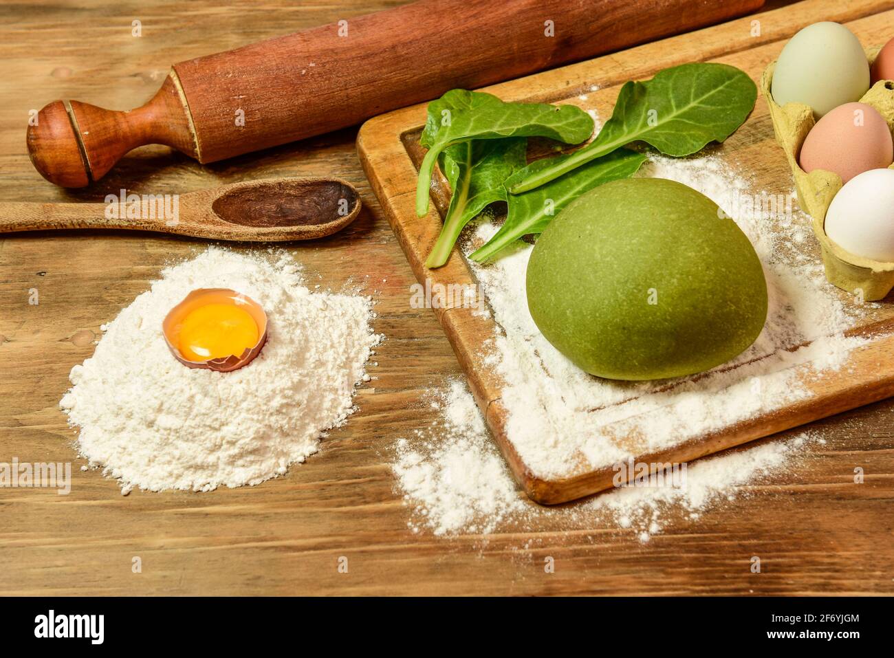 Green dough bun for making noodles, prepared on the table with