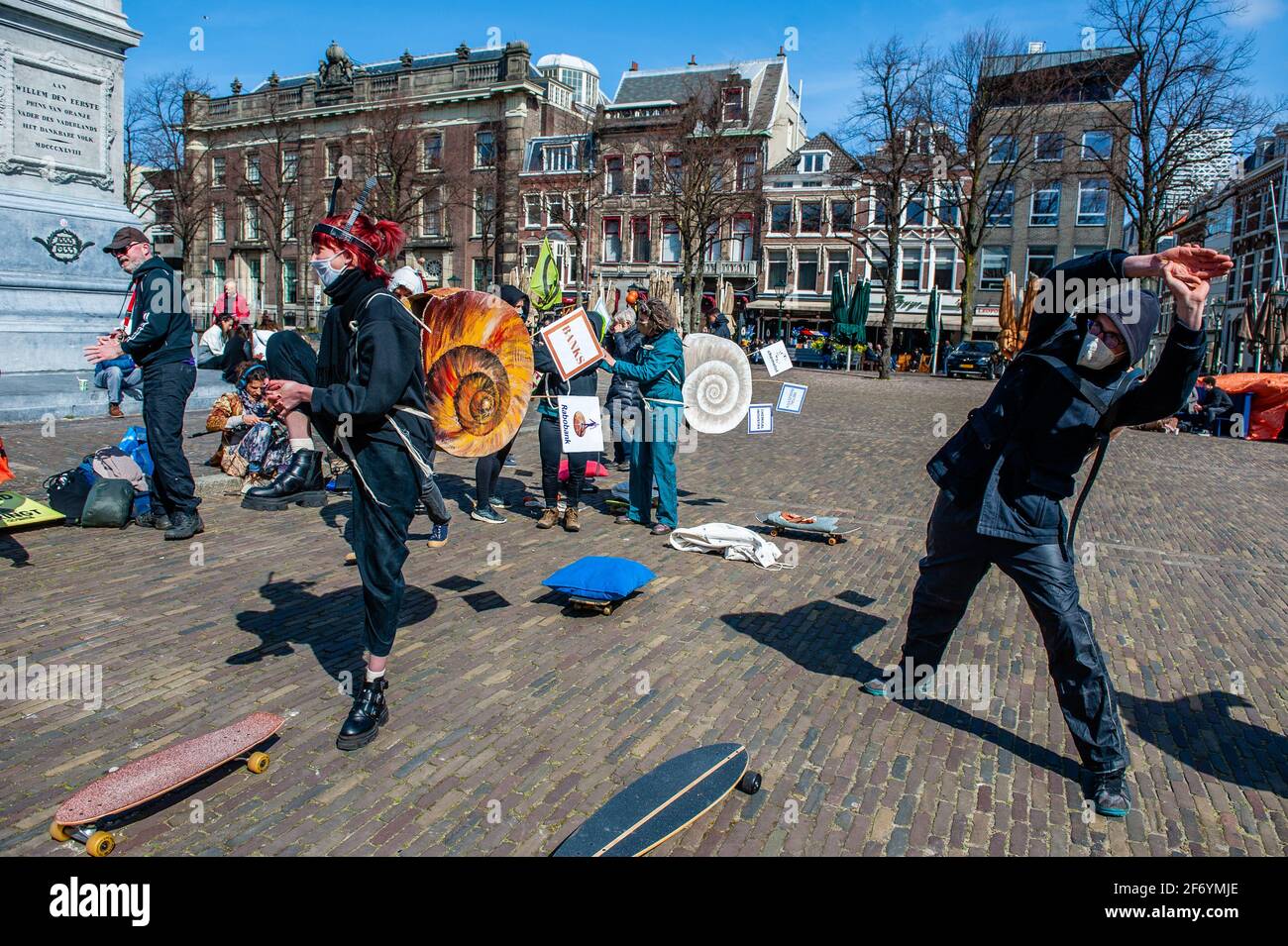 The XR activists dressed like snails are seen stretching before the