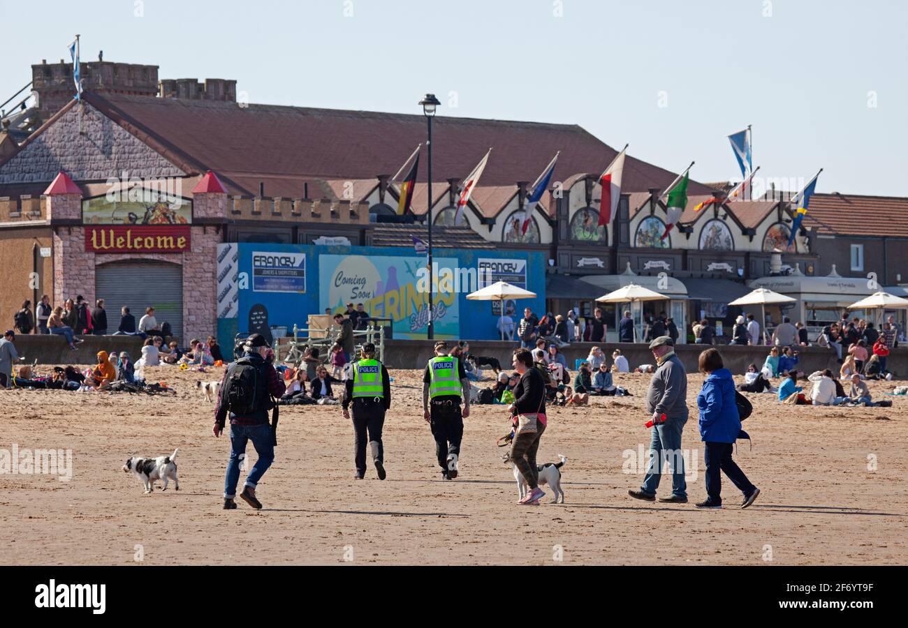 Portobello, Edinburgh, Scotland, UK weather. 3rd April 2021.Busy Easter Saturday for this first weekend of the 'Stay Local restriction' as the sunshine brought the crowds out at the seaside, temperature around 13 degrees. Pictured: Police on the beach on routine patrol. Stock Photo