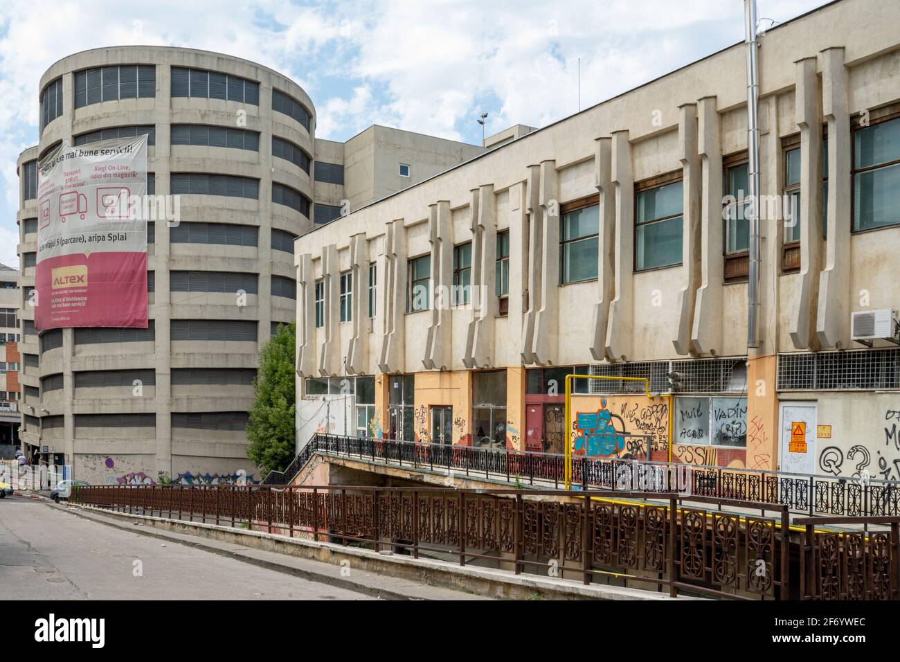 Socialist modernism or constructivism scruffy constructions and round tower on Mamulari st., Bucharest, Romania Stock Photo