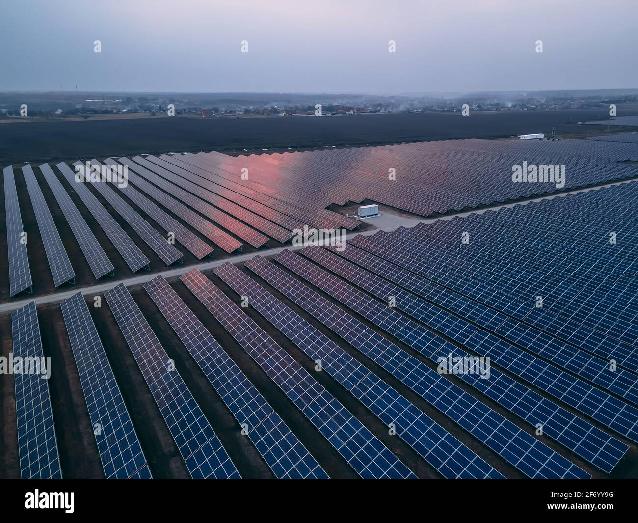 Aerial drone view of large solar panels at a solar farm at bright ...
