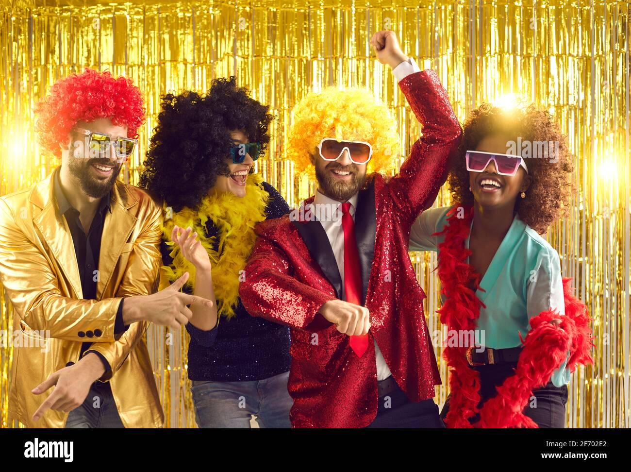 Group of happy people in fancy costumes dancing gangnam style and having fun at the club Stock Photo