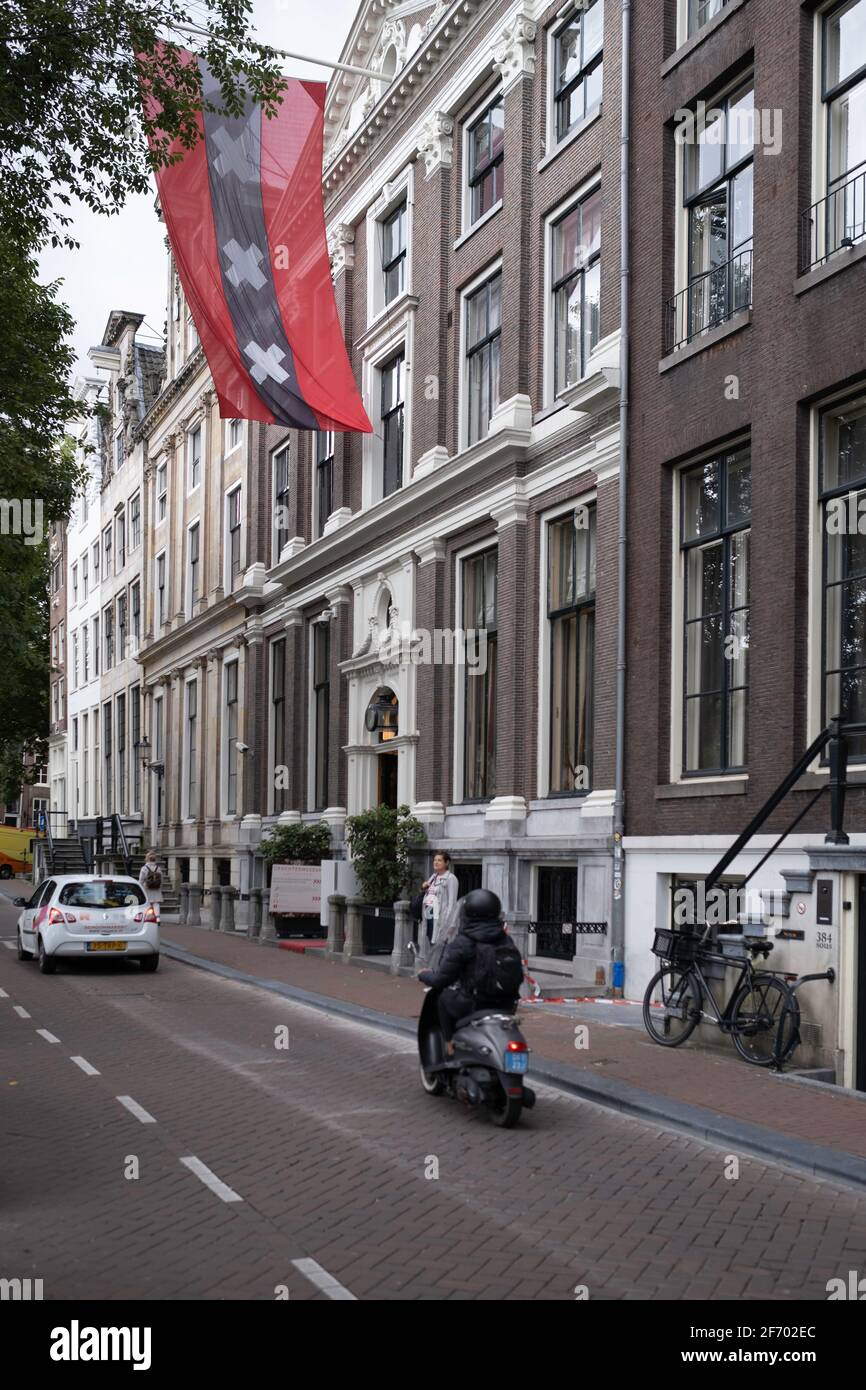 Grachtenmuseum or Museum of the Canals with city flag on the Herengracht shows the history of the origins of the buildings and canals in Amsterdam Stock Photo