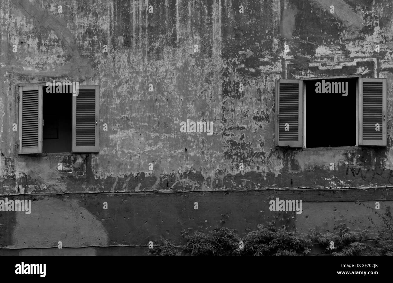 Two open windows in a weathered wall Stock Photo Alamy