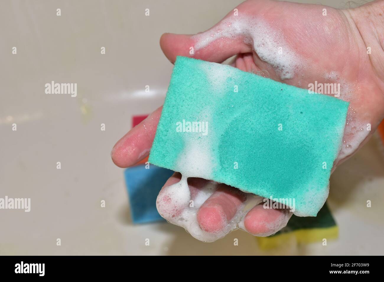 Sponge with detergent and foam while washing. Cleaning Kitchen