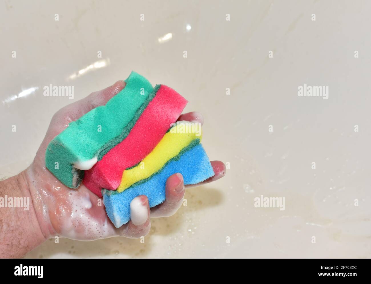 Sponge with detergent and foam while washing. Cleaning Kitchen