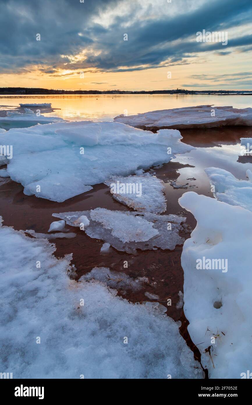 Winter landscape with frozen ice sheets floating on a lake during a