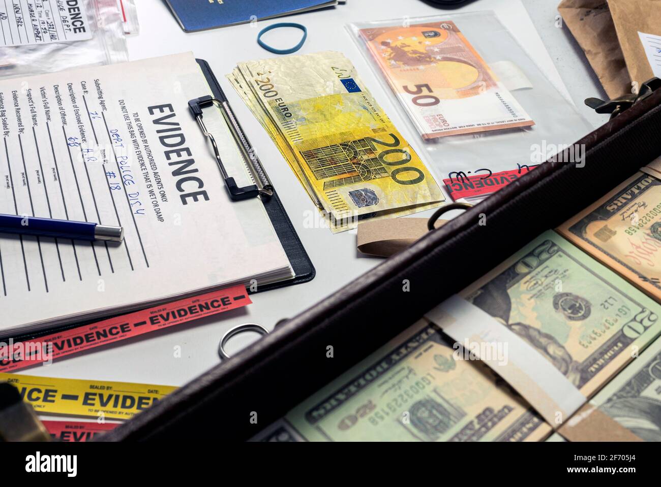 dollar bills and passports in criminal investigation unit, conceptual image Stock Photo