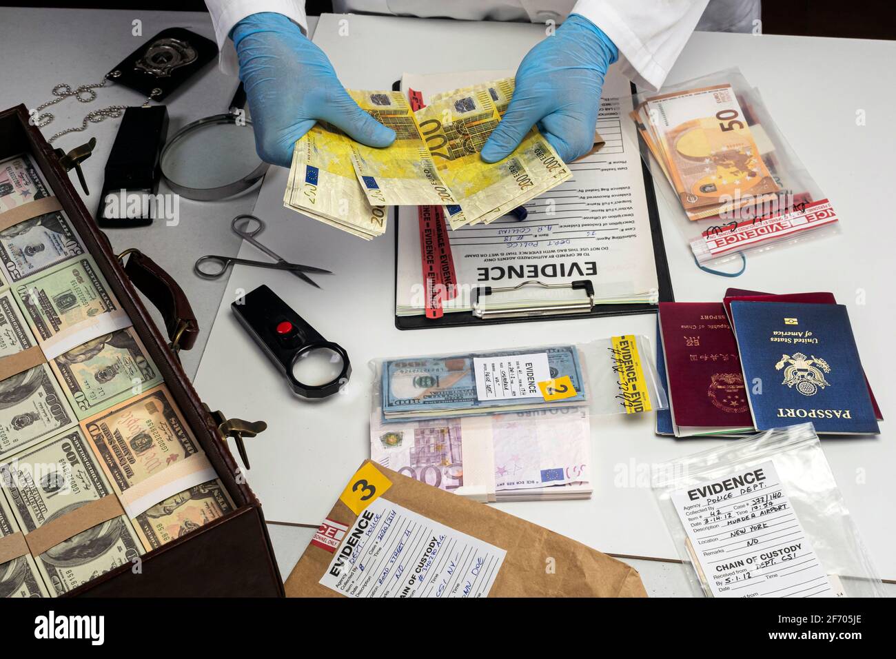 Specialised police officer Counting euro banknotes in crime lab, conceptual image Stock Photo