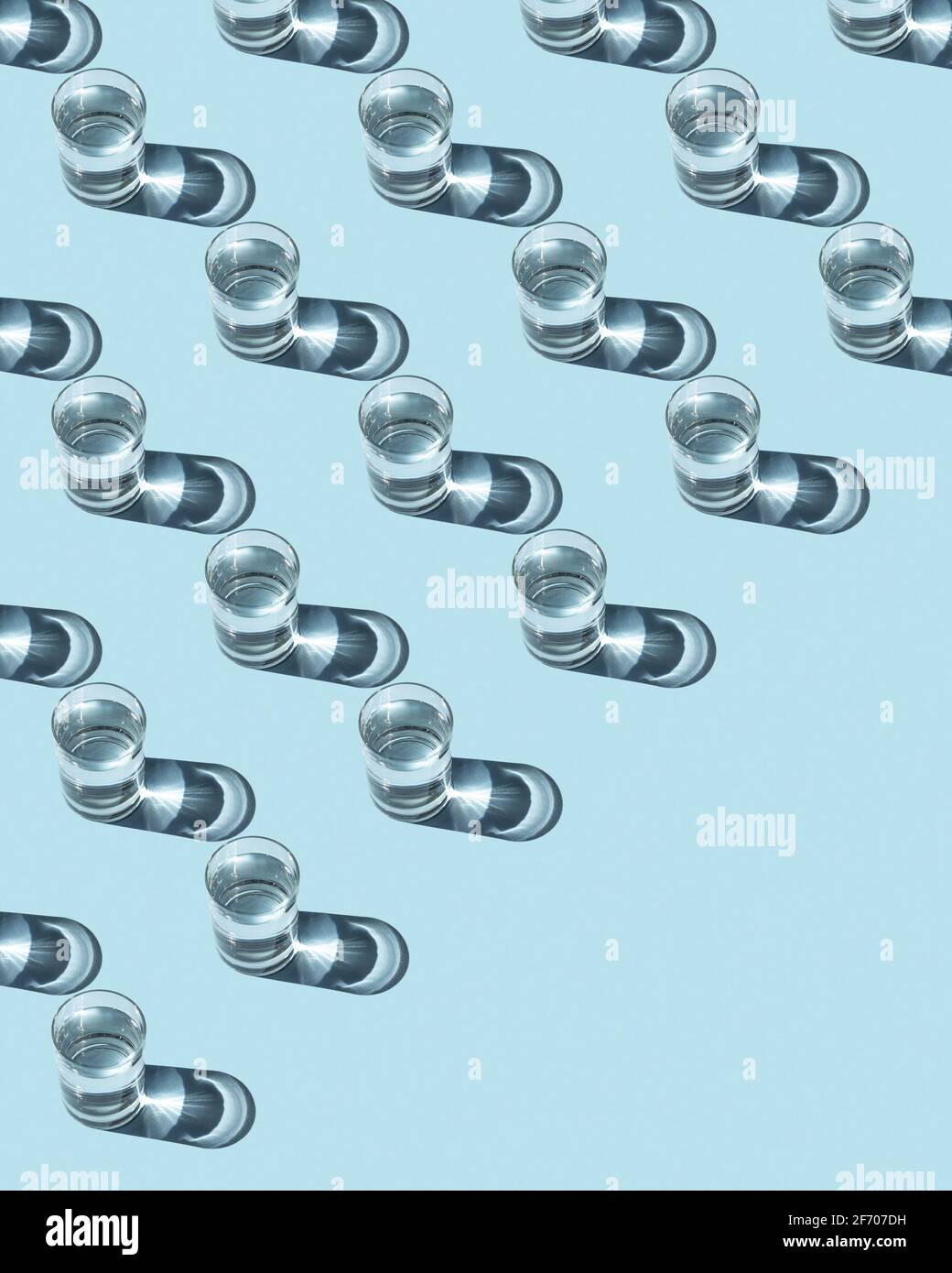 Pattern from glasses with water on a blue background. Ecological concept. Stock Photo