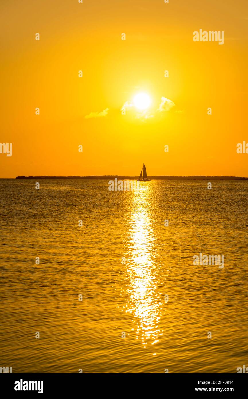 Sailboat sailing in to the sunset, Key Largo, Florida USA Stock Photo
