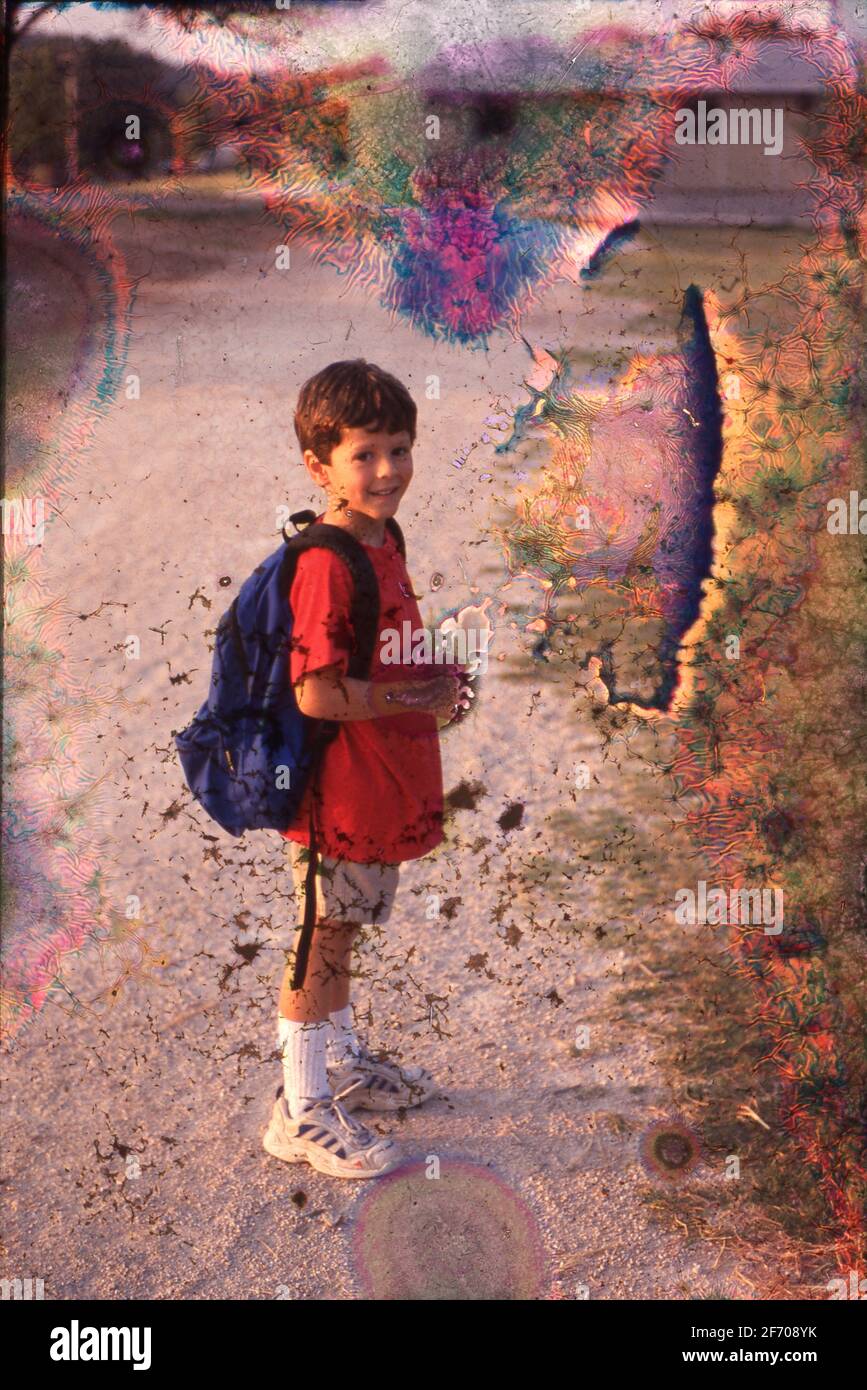 Austin, Texas USA, 1999: 5-year-old Anglo boy carries backpack on pathway to his school building. ©Bob Daemmrich Stock Photo