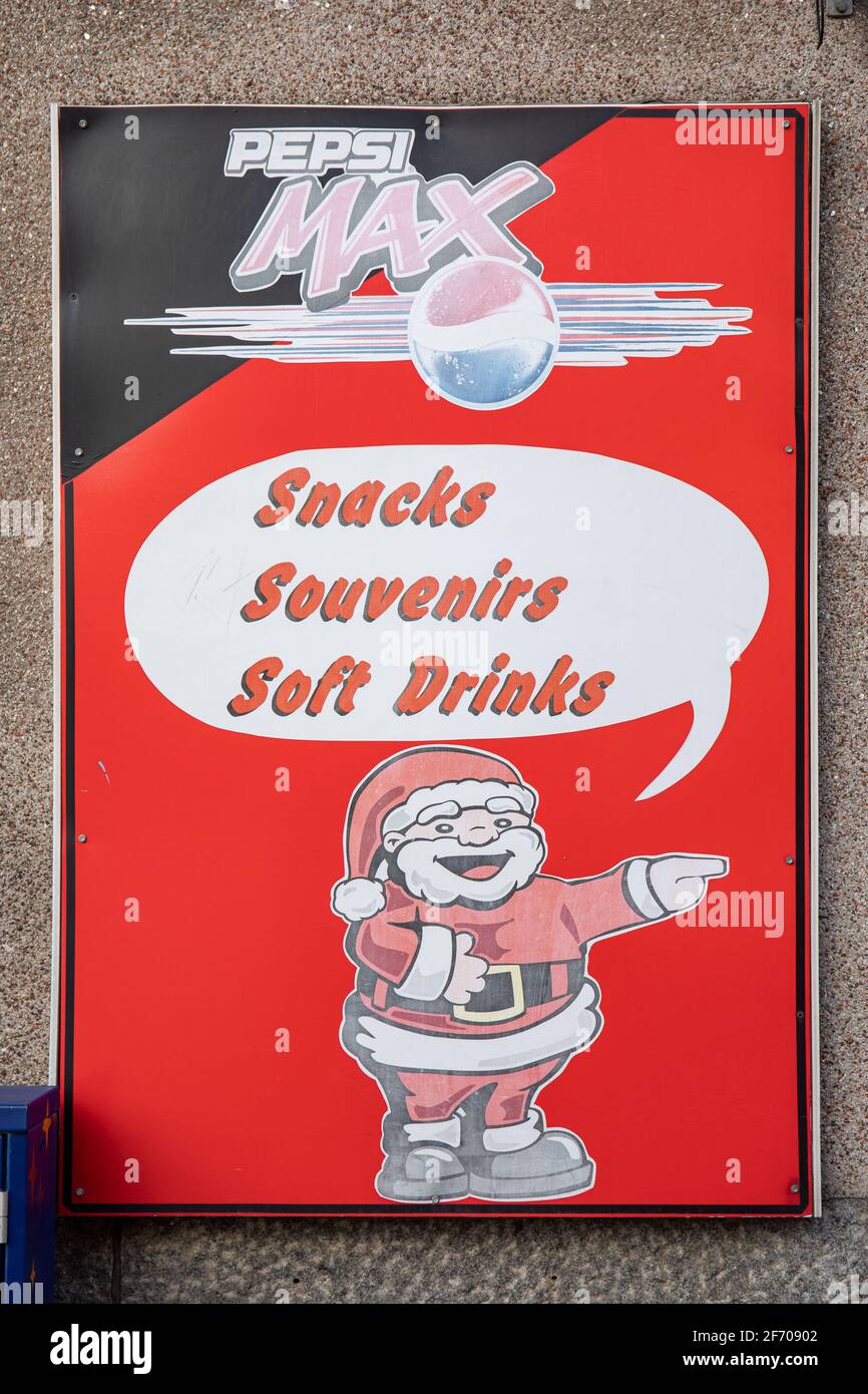 Faded sign on Santa's Minimarket or Souvenir Shop door in Etu-Töölö district of Helsinki, Finland Stock Photo