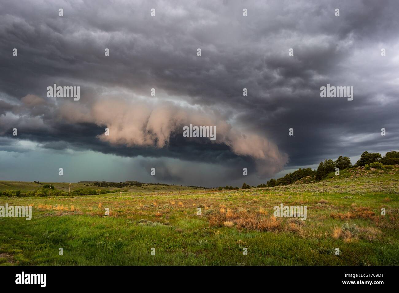 Dramatic storm cloud and rain-wrapped tornado approaching Glendo, Wyoming Stock Photo