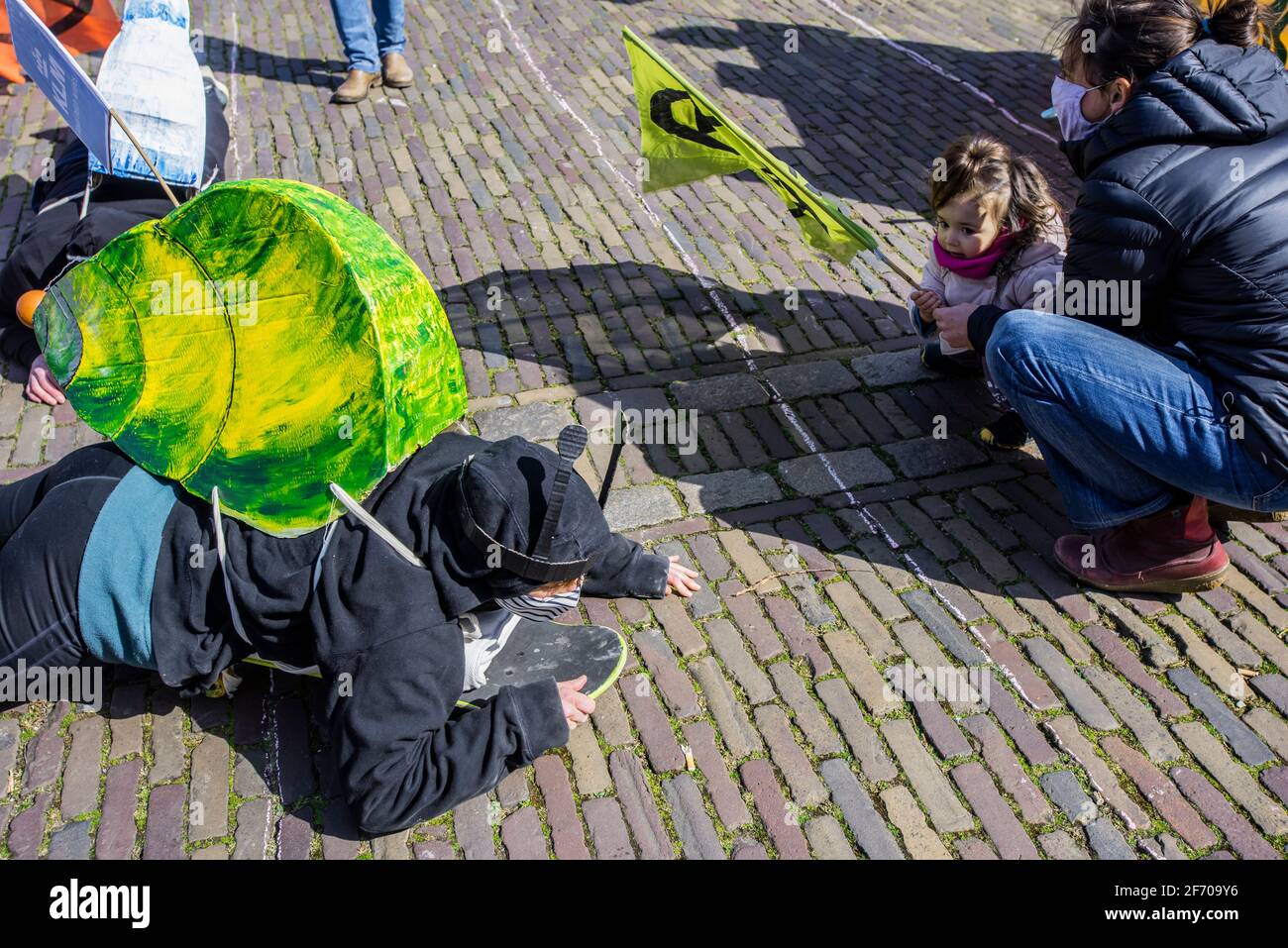 Plein, The Hague, Netherlands. Saturday 3rd April, 2021. At a snail's pace! Symbolizing the slow movement of nations towards a net-zero emissions policy. Extinction Rebellion this afternoon put-on a symbolic race to the finish, toward a finish line that wasn't reached! Each snail representing a multinational and, as most experts now agree: The Paris Agreement will not be sufficient to prevent a Global temperature rise of 1.5o C. The Paris Agreement's main aim was to highlight; strengthen the global response to the threat of climate change, and to achieve a temperature rise this century well b Stock Photo