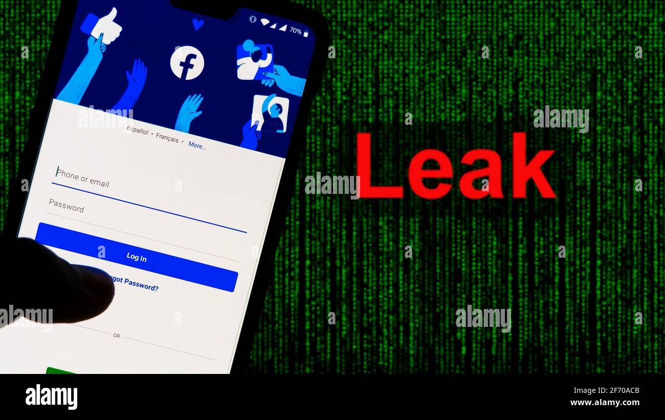 Facebook's massive data breach. Facebook App aginst Leak text in red and Matrix-style green background. 533 Million Facebook User's personal informati Stock Photo