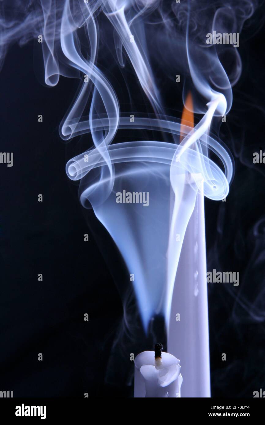 the smoke and burning two candles Stock Photo Alamy