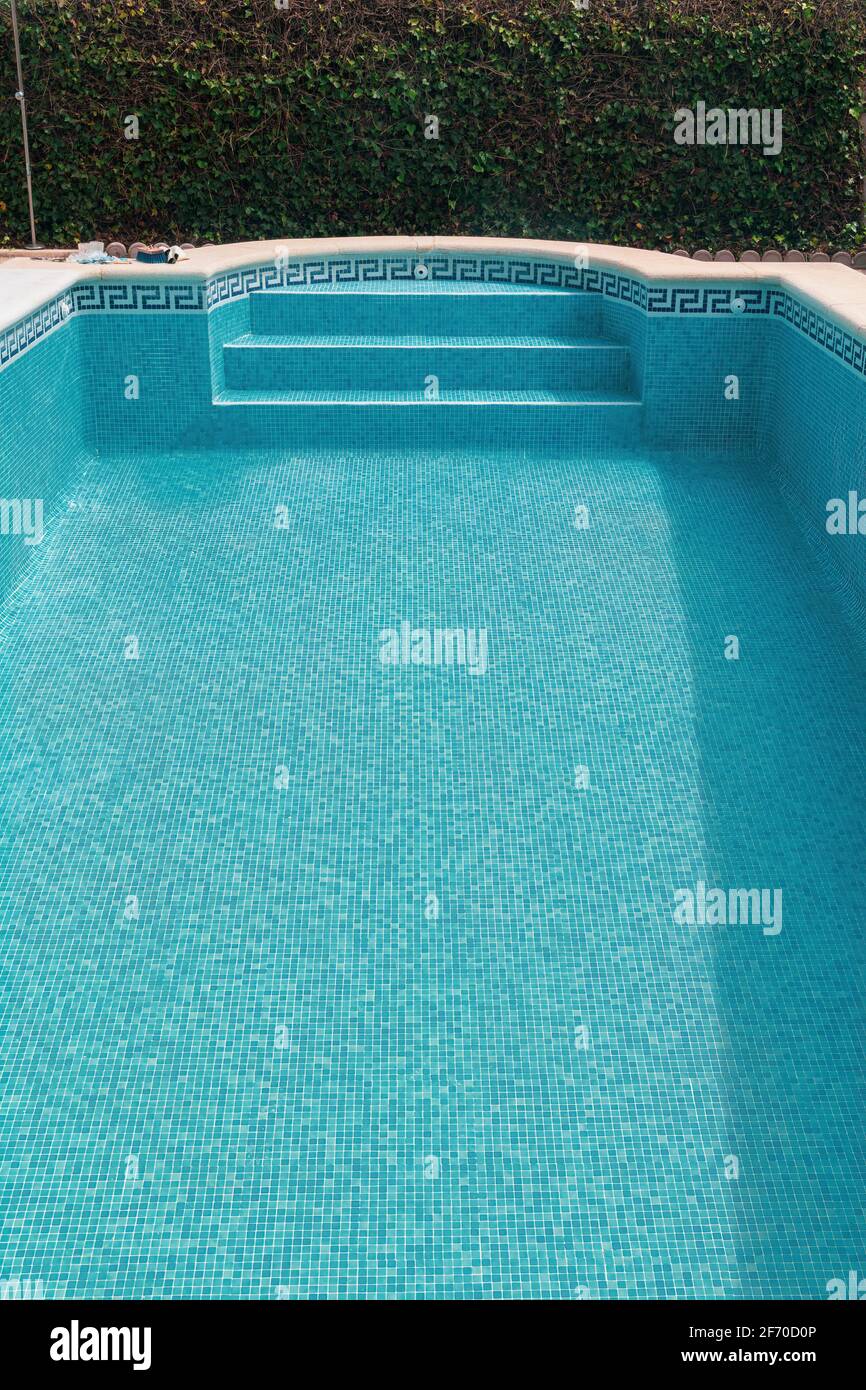 Empty swimming pool with blue tiles Stock Photo - Alamy