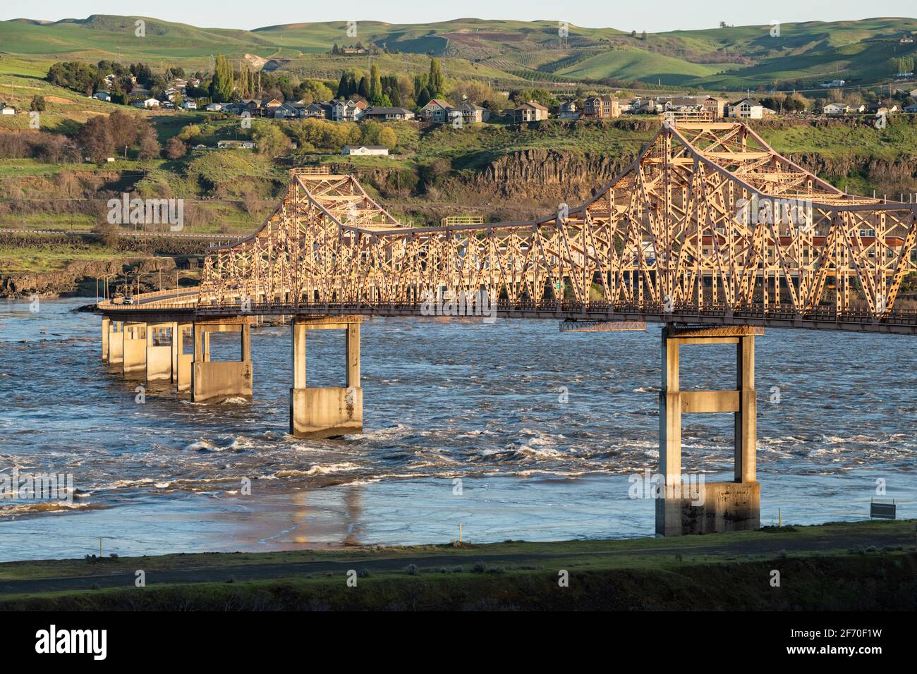 The orange painted steel Dalles Bridge crossing the Columbia River