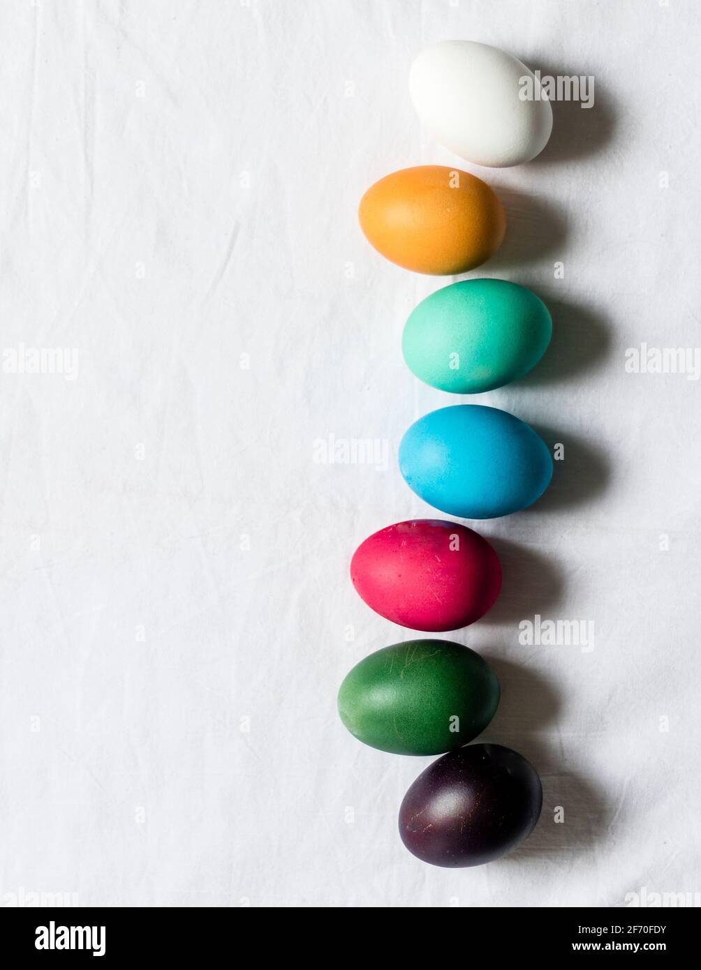 Easter, minimalistic scene - dyed eggs lying on a table, ready to be place in Easter basket. Stock Photo