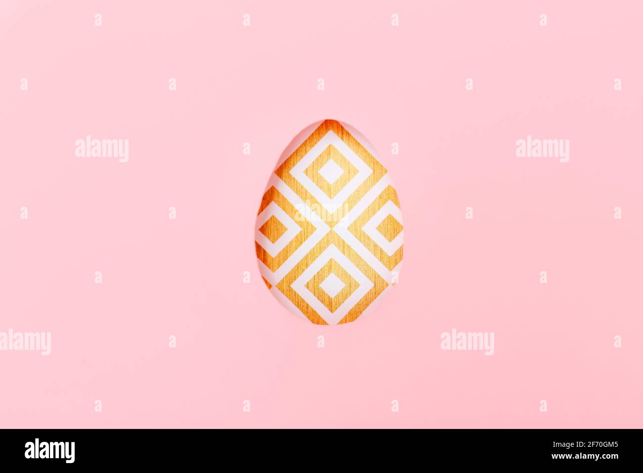 One colored Easter egg on pink paper, top view Stock Photo