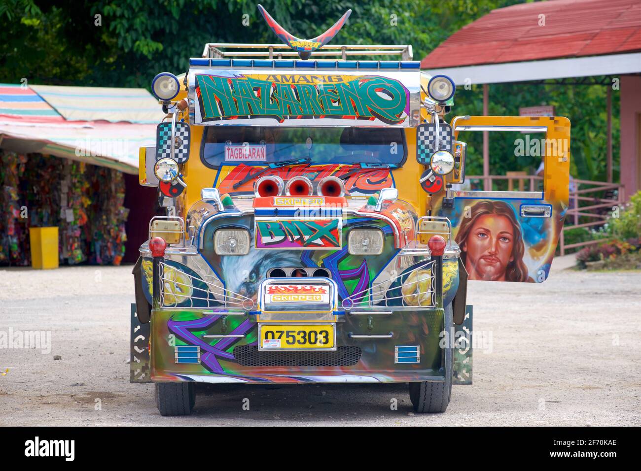 Filipino Jeepney, decorated with painted image of Jesus Christ. Cebu, Philippines. Stock Photo