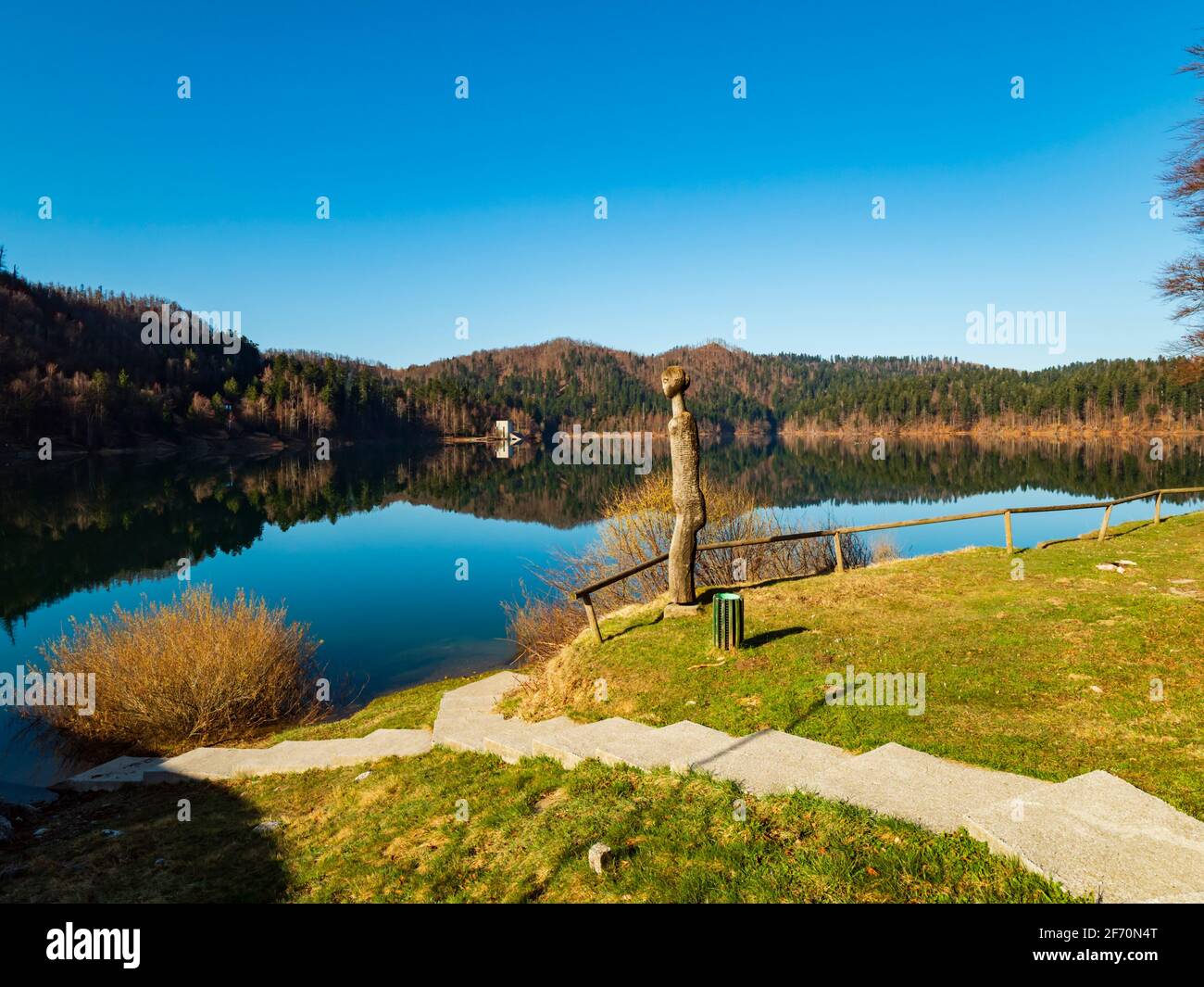 Wooden statue sunshine sunny sunlight Lokve lake in Croatia Europe Stock Photo