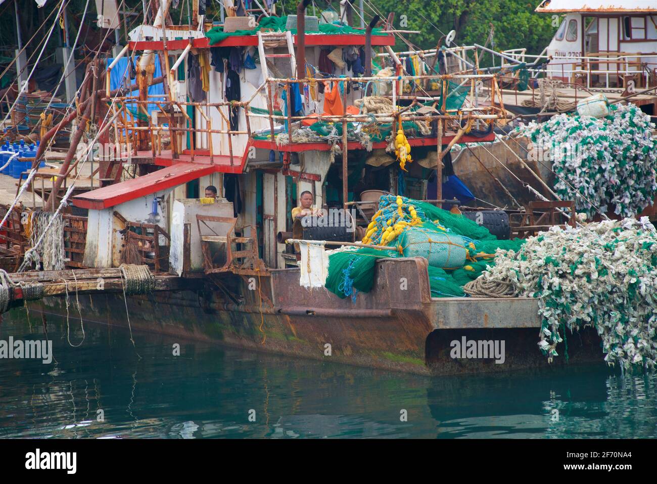 Fishing boats line the coastal of Punta, Cebu Island. On approach to the port at Hagnaya. Philippines Stock Photo