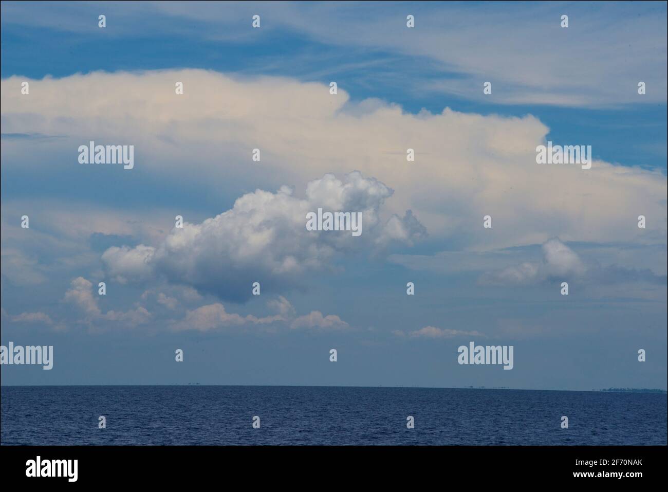 Fluffy clouds in a blue sky above the Visayan Sea between Cebu and Bantayan Islands. Philippines Stock Photo