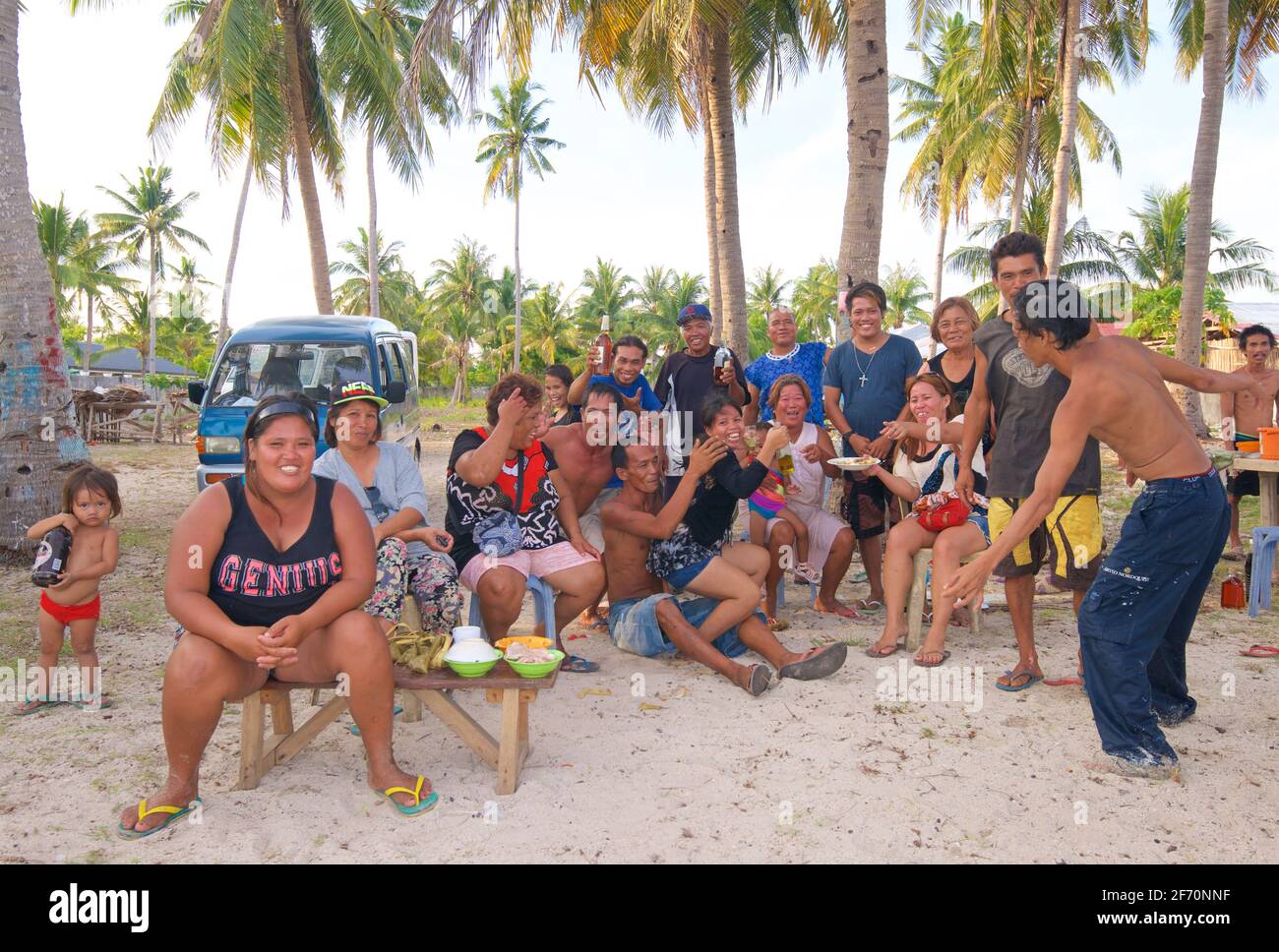 Filipino family and friends enjoying the beach together and a few drinks. Santa Fe, Bantayan Island, Cebu, Philippines Stock Photo